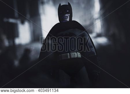 JAN 12 2021: Batman standing over a thug in a dark alley in Gotham City - Mego Corporation action figure
