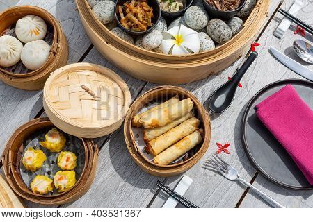 Dimsum Hagao In Chinese Bamboo Basket. Gyoza On A Wooden Table In A Restaurant. Assorted Asian Food 