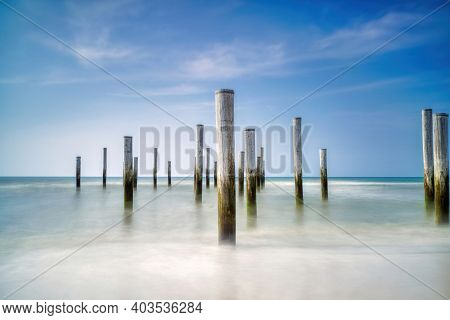 Focus On Flong Exposure Seascape. Taken At The North Sea In Petten With The Pole Village In The Sea,