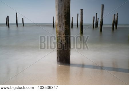Focus On Flong Exposure Seascape. Taken At The North Sea In Petten With The Pole Village In The Sea,