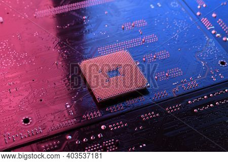 Computer Cpu Processor Chip On Circuit Board ,motherboard Background. Close-up. With Red-blue Lighti