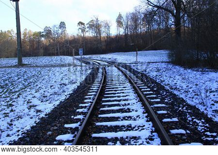 Railway Tracks Run Away From The Viewer In A Curve