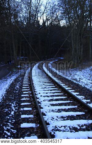 Railway Tracks Run Away From The Viewer In A Curve