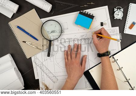 Mechanical Drawing On Sheets Of Paper. Hands On The Table Top View. Workflow Of An Architect, Engine