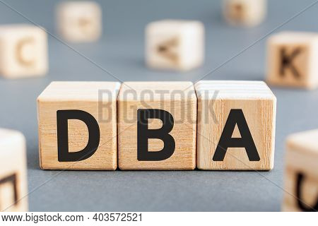Dba - Acronym From Wooden Blocks With Letters, Database Administrator Or Doing Business As Abbreviat