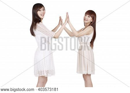 Portrait Of Two Female Friends Claping High Quality Photo