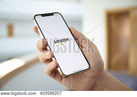 Alanya, Turkey - December 18, 2020: Man Hands Holding Iphone 12 Pro Max Gold With Online Internet Sh