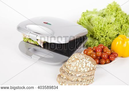 Sandwich Maker Gray With Food; Photo On White Background.