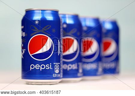 Kharkov, Ukraine - December 8, 2020: Aluminium Cans Of Pepsi Soft Drink On White Wooden Table. Pepsi