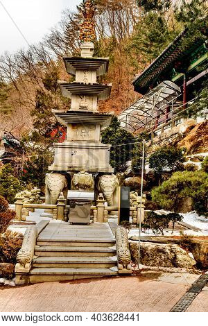 Four Story Stone Carved Pagoda On Plinth Of Three Elephants At Buddhist Temple.