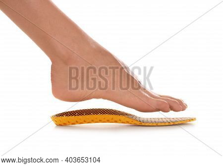Woman Fitting Orthopedic Insole On White Background, Closeup. Foot Care