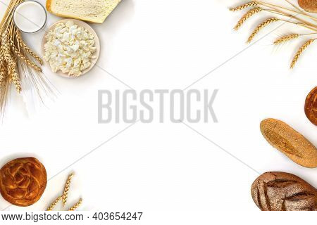 Frame Of Cheese, Barley And Wheat And Milk In Glass, Different Fresh Baked Bread, On A White Backgro