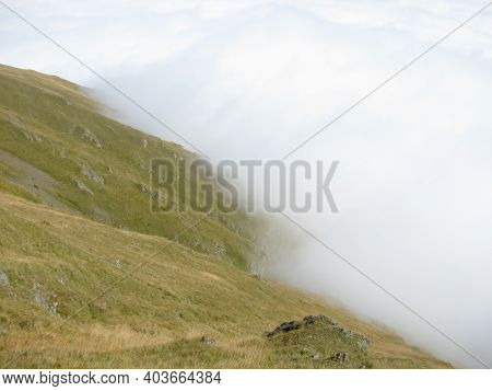 Russia, North Ossetia. The Road To The Fiagdon Relay. The Green Slope Of The Mountain And The White 