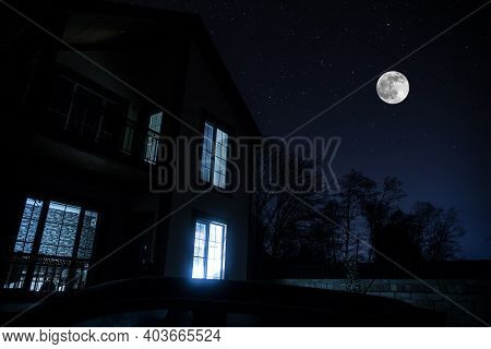 Old House With A Ghost In The Forest At Night Or Abandoned Haunted Horror House In Fog. Old Mystic B