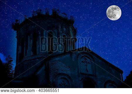 Old House With A Ghost In The Forest At Night Or Abandoned Haunted Horror House In Fog. Old Mystic B