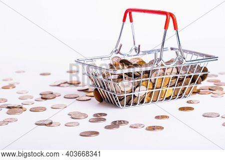 Metal Basket With Metal Money Coins On White Background - Multicurrency Basket Concept