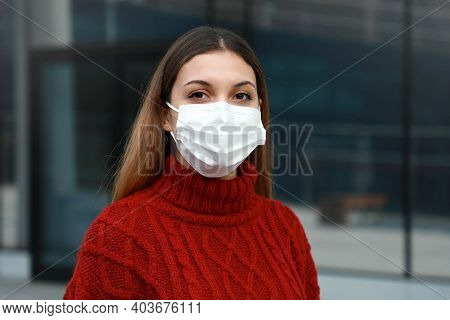 Portrait Of Young Woman With Surgical Mask Ready For Mass Vaccination Looks At Camera