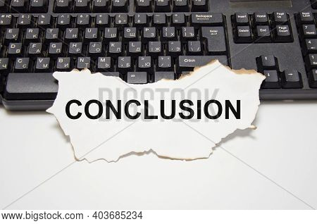 The Word Conclusion Is Written On A White Sheet Of Paper That Lies On The Computer Keyboard