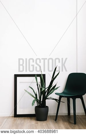 Minimal Interior Design Of Living Room With Green Chair And Houseplan.