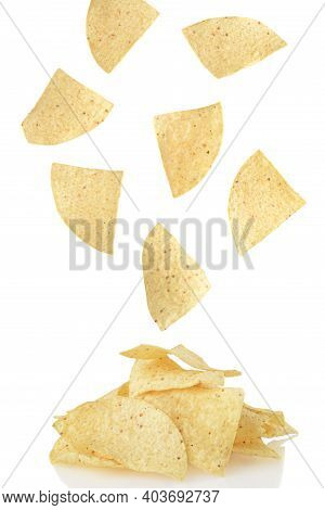 Nacho Chips Falling Onto A Pile With White Background