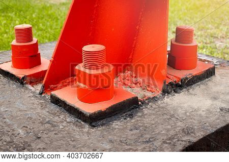 The Red Metal Support Is Bolted To The Concrete Base With Large Bolts. Fixing A Tower Or Tower To Th