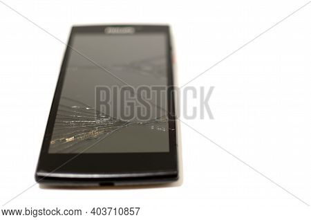 Black Cell Phone With Broken Screen. Electronic Equipment Repair Concept. Crack On Smarton Glass.