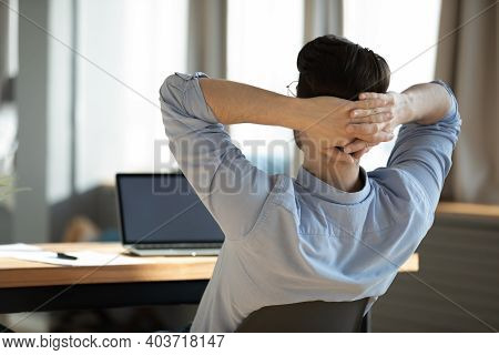 Happy Young Male Worker Employee Resting On Chair During Workday.