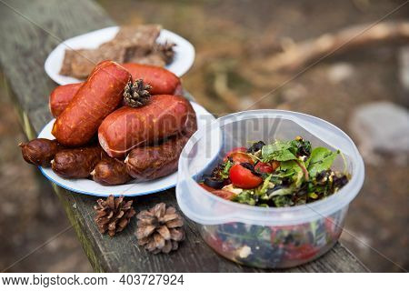Sausages, Bread And Salad - Food To Prepaire On A Fire. Concept Of Outdoor Cooking.