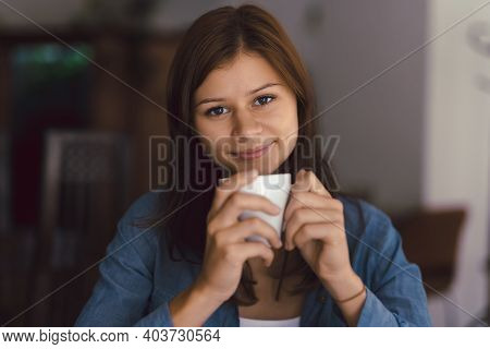 Young Girl In Cafe With Cup Of Hot Chocolade