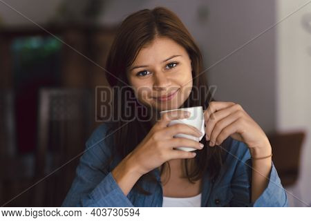 Young Girl In Cafe With Cup Of Hot Chocolade Or Coffee