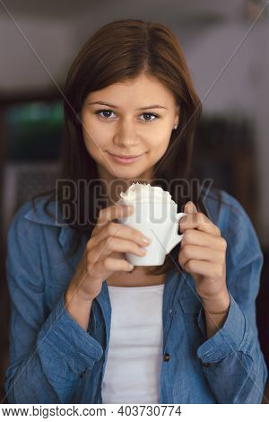 Young Girl In Cafe With Cup Of Hot Chocolade With Cream