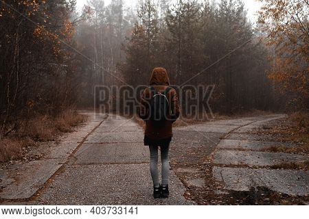 Girl With Backpack From Behind At The Crossroad And Don't Know Which Way To Go