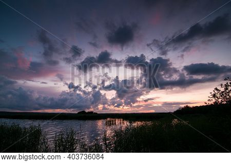 Sunset With Blue And Magenta Vlouds Over Lake In Sweden.