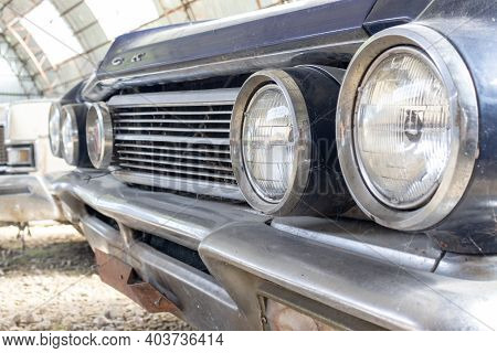 A Headlight Of A Retro Old Car Close Up In A Junk Yard, Recycling Fee Concept