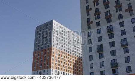 Bottom View Of The Facade Of A New High Rise Apartment Buildings With Glass Windows And Small Balcon