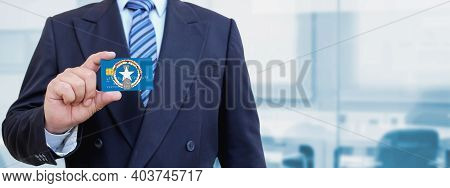 Cropped Image Of Businessman Holding Plastic Credit Card With Printed Flag Of Northern Mariana Islan