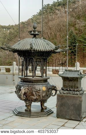 Danyang-gun, South Korea; Jan. 13, 2021: Ornate Metal Incense Candle Burner On Patio Of Guinsa Templ