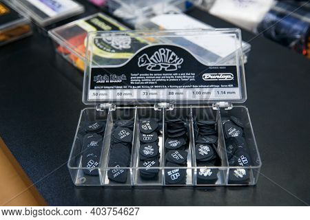 Zaporozhye, Ukraine - 14.03.2020 Black Picks For Playing Guitar Are In A Transparent Container.