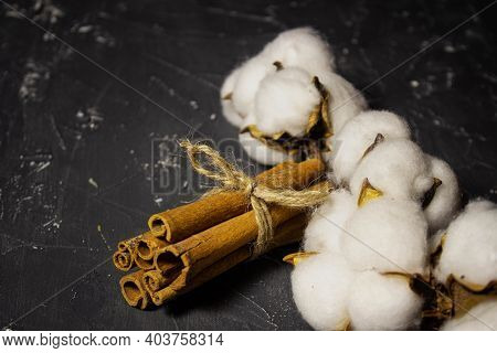 Cinnamon And Cotton On Dark Gray Background. Style