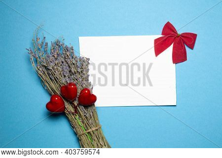 Valentines Day Congratulation. Red Rose And Greeting Card With Heart Sign On Blue Background Top Vie
