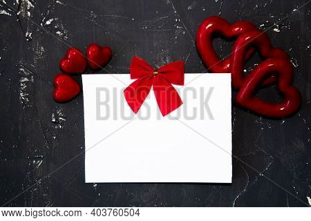 Valentines Day Congratulation. Red Rose And Greeting Card With Heart Sign On Black Background Top Vi