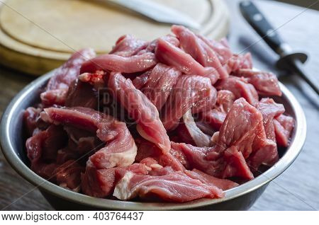 Cooking Beef Meat Dishes. A Portion Of Raw Meat For Beef Stroganoff In A Metal Bowl. Cutting Board, 