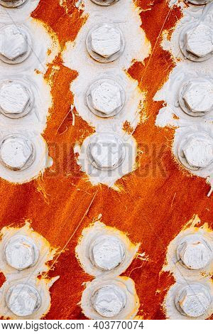 The Texture: Abstract Background Of Bolts And Nuts Painted White On A Red Background