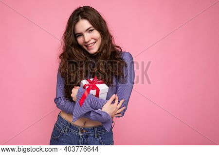 Photo Of Pretty Positive Smiling Brunette Curly Young Woman Isolated On Pink Background Wall Wearing