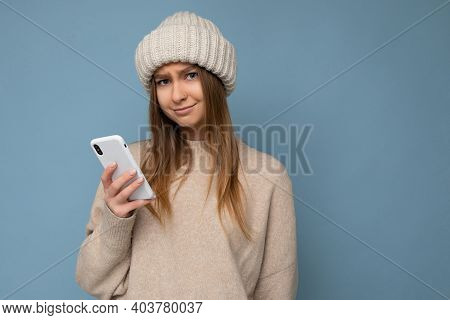 Photo Of Beautiful Upset Young Blonde Woman Wearing Stylish Beige Warm Sweater And Knitted Winter Wa