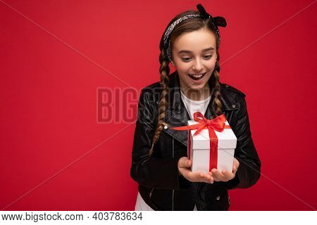 Photo Of Beautiful Happy Brunet Girl Isolated Over Red Background Wall Wearing White Casual T-shirt 