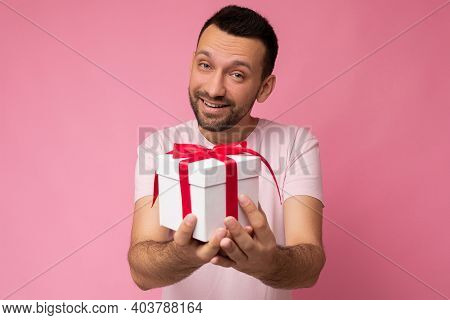 Photo Shot Of Handsome Positive Brunette Unshaven Young Man Isolated Over Pink Background Wall Weari