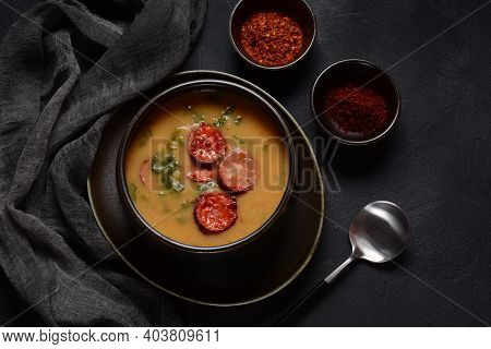 Caldo Verde Soup With Greens And Chopped Chorizo On The Top In The Bowl On A Dark Background.