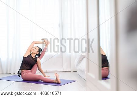 Young Woman Do Yoga In A Bed Room