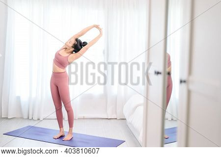 Young Woman Do Yoga In A Bed Room